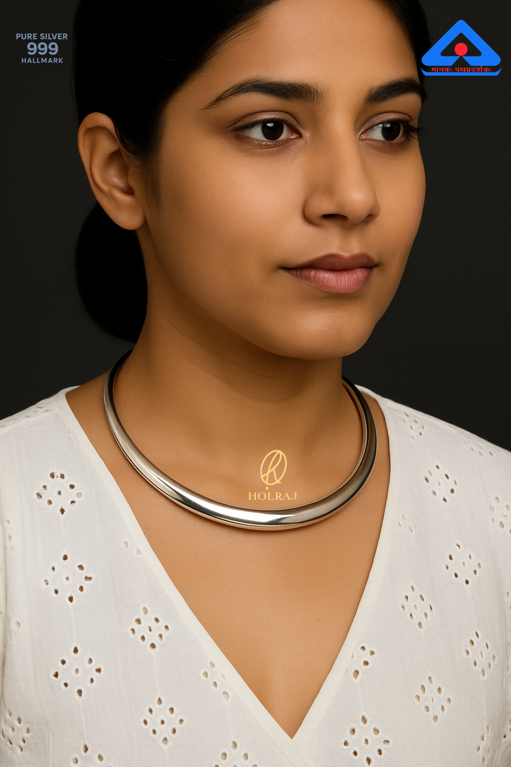 Aarohi Hansuli by Holraj, smooth pure 999 silver choker necklace worn by an Indian woman in a white embroidered blouse.