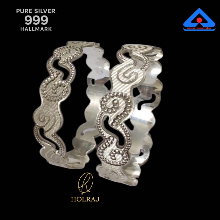 Pair of pure 999 silver bangles featuring a wavy edge and paisley engravings, displayed on a black background with hallmark and Holraj logo.