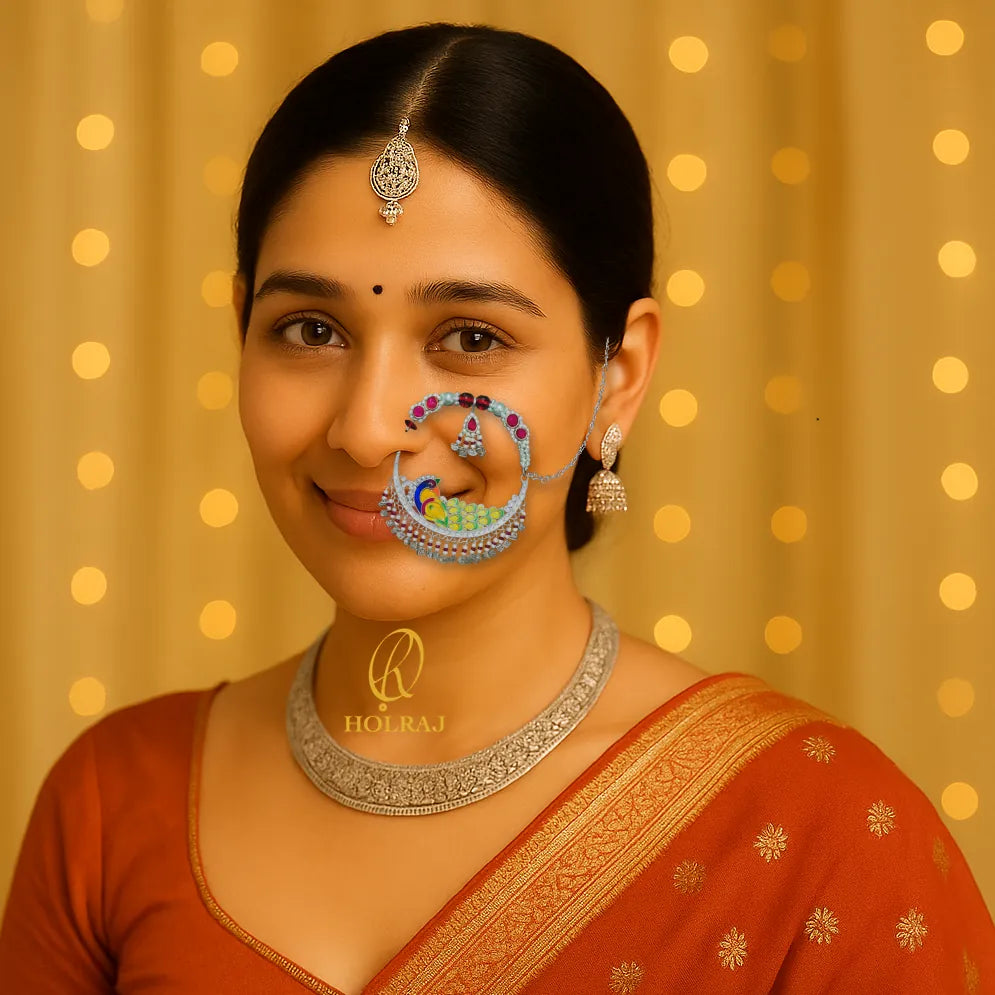 A woman wearing BIS Hallmarked 999 pure silver elaborate Tehri Nath or Nathuli or traditional pahadi Nosering with colorful peacock enamel and beads, inspired by Uttarakhand’s bridal jewelry.