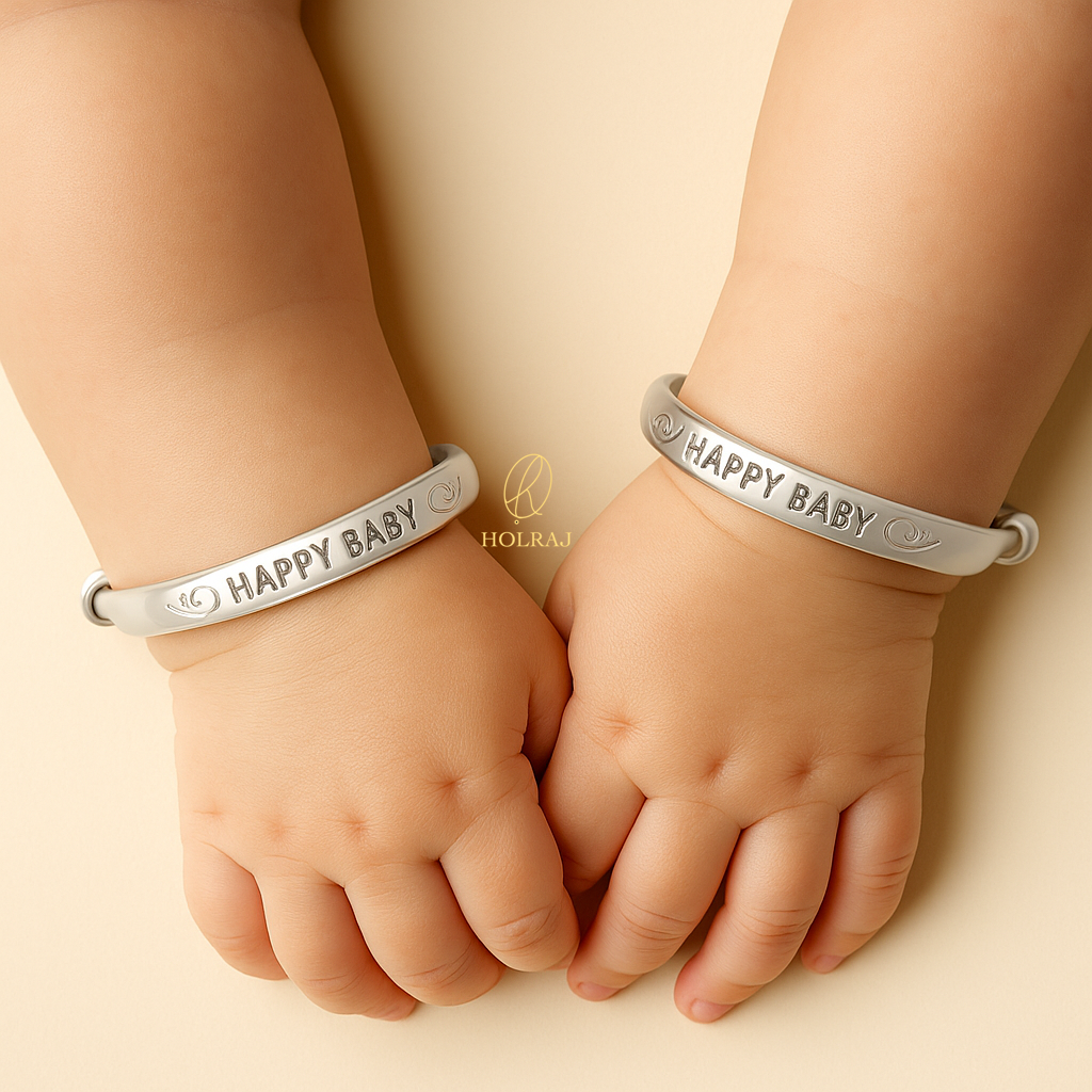 Two baby hands wearing Holraj branded BIS Hallmarked 999 pure silver 'Happy Baby' kada or bangles or bracelets.