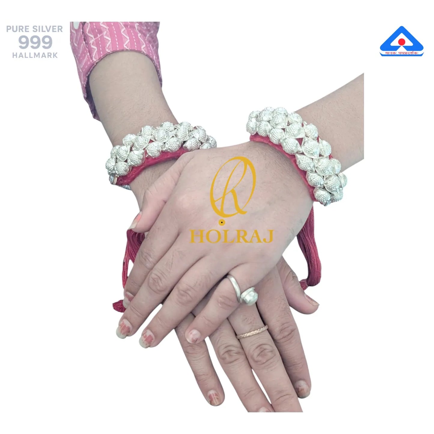 Hands wearing Holraj branded 999 purity silver Raj Ponchi with a visible brand logo on a white background