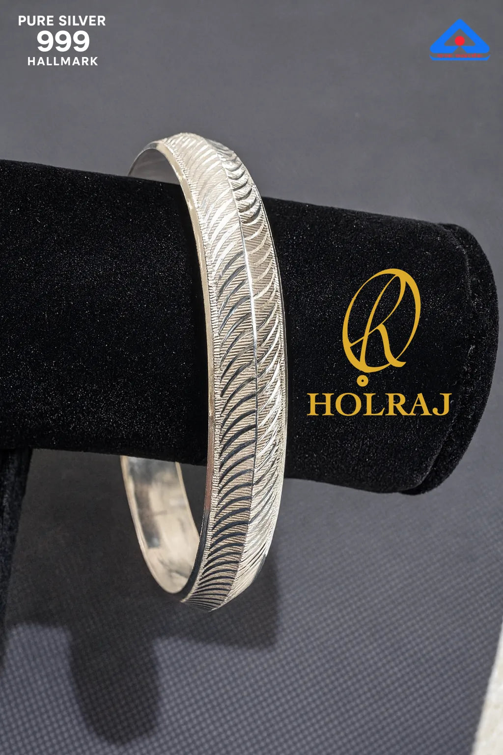 99.9 % pure Silver kada on a black stand with Holraj logo