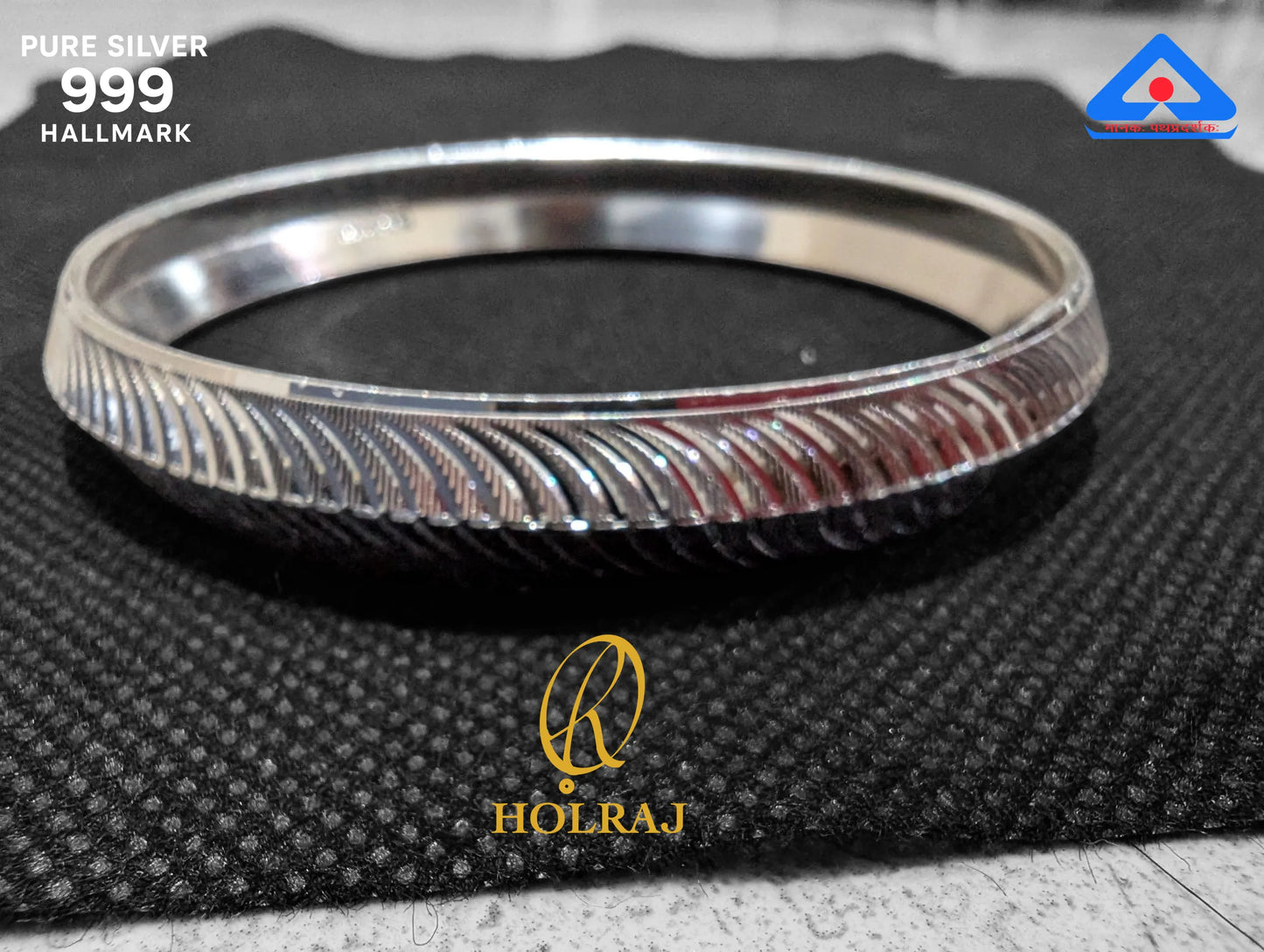 Silver kada for men containing 99.9% silver with 'HOLRAJ' branding on a textured black surface