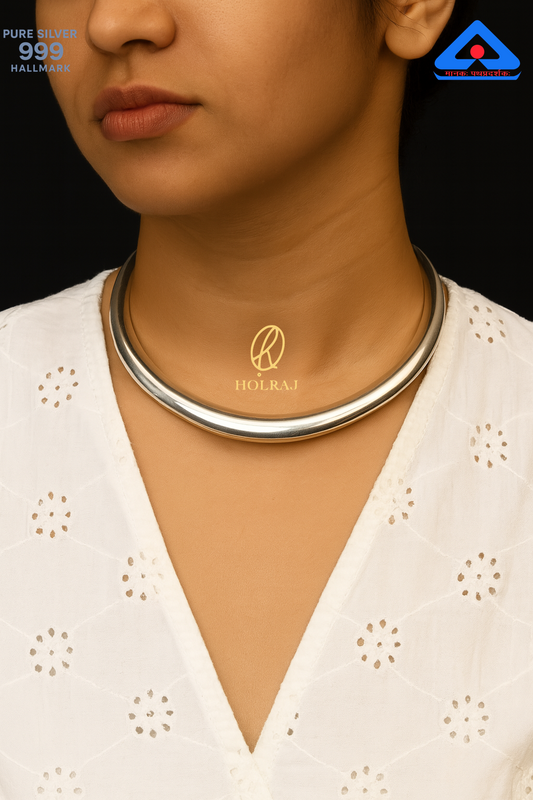 Aarohi Hansuli by Holraj, smooth pure 999 silver choker necklace worn by an Indian woman in a white embroidered blouse.