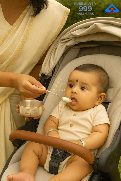 Indian baby in stroller wearing engraved silver bangles, being fed by mother with 999 silver spoon and bowl from BalKripa™ Gift Set by Holraj