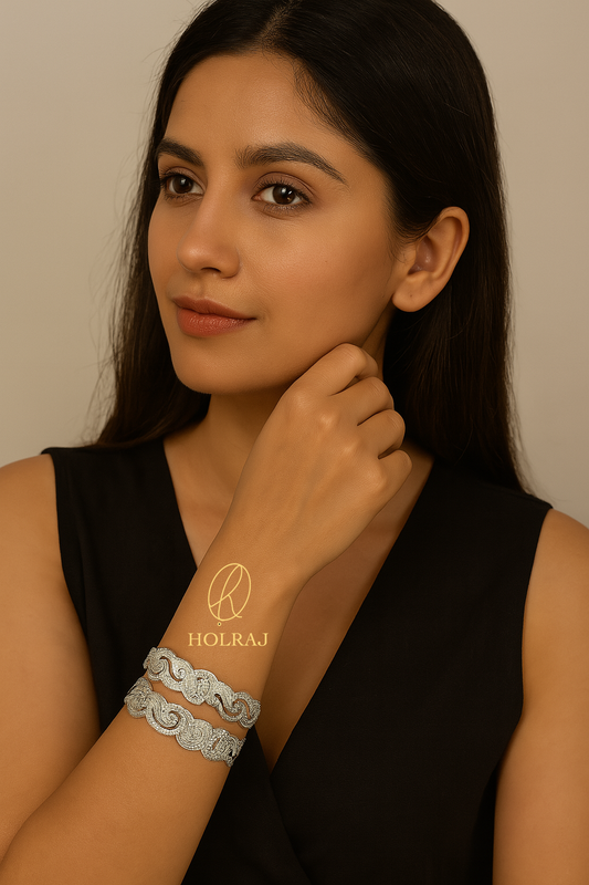 Woman wearing holraj branded BIS Hallmark 999 pure silver bangles or kada featuring a wavy edge and paisley engravings.
