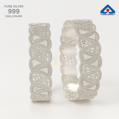 Pair of high-polish 999 pure silver bangles with intricate triangular cutwork and beaded borders, set against a clean white background with BIS Hallmark and Holraj branding.