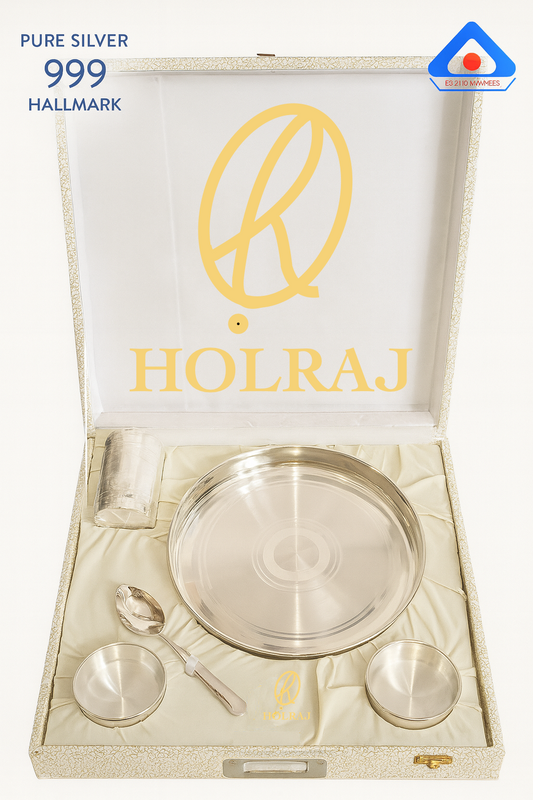 Pure 999 silver dining gift set by Holraj includes thali, tumbler, spoon, and two katoris in a cream velvet-lined box, BIS hallmarked, with optional engraving.