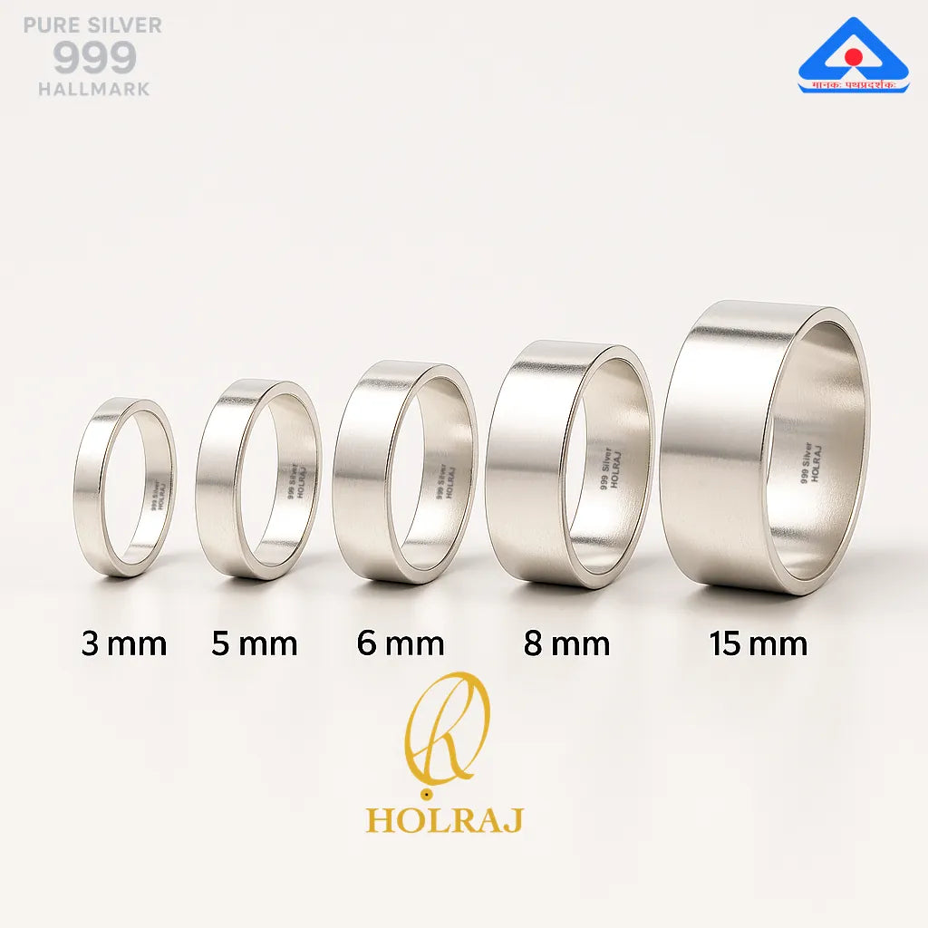 Set of 'HOLRAJ' branded 999 silver rings with different widths namely 3 mm, 5mm, 6 mm, 8 mm and 15 mm placed upright with a white background.