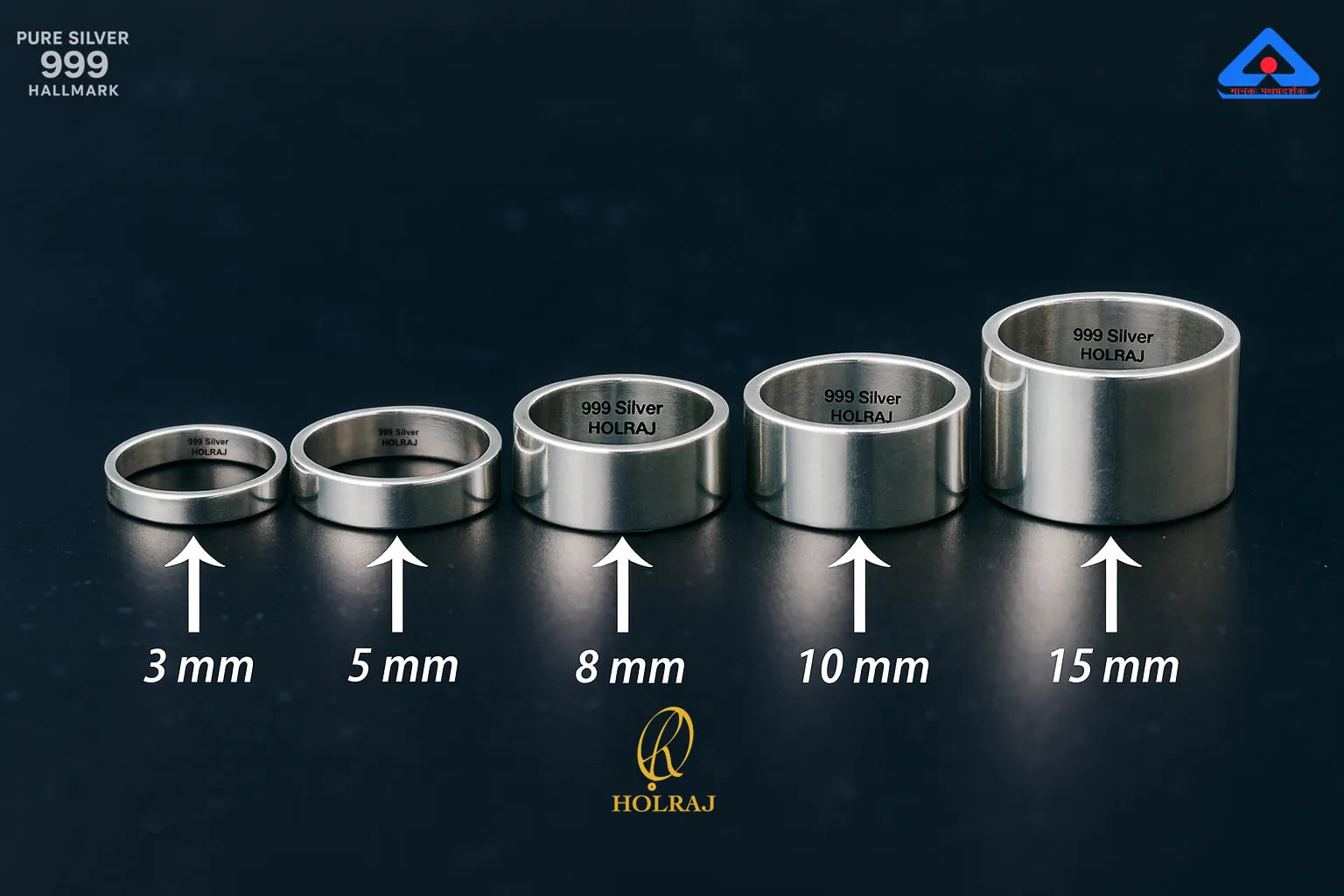 Set of Holraj Branded 999 purity silver rings with size indicators on a dark background placed flat on a dark surface.