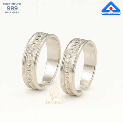Pair of heritage-inspired silver toe rings with dotted ridge and oxidized finish by Holraj
