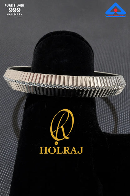 Hallmark certified RajRidhi 999 silver kada by Holraj with dotted central engraving – angled view