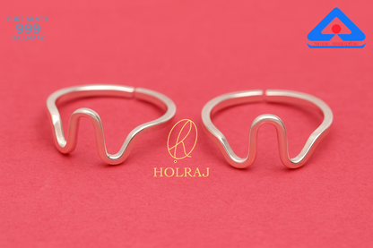 Two 999 silver Toe ring designs on a red background with 'HOLRAJ' branding.