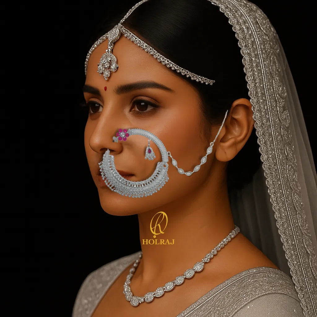 Woman wearing traditional jewelry with a dark background, prominently featuring the Holraj branded 999 pure silver nath nosering.