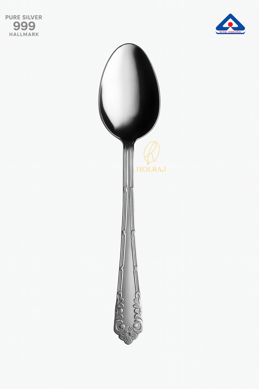 Pure silver spoon with ornate handle design on white background – 999 hallmark certified. By Holraj